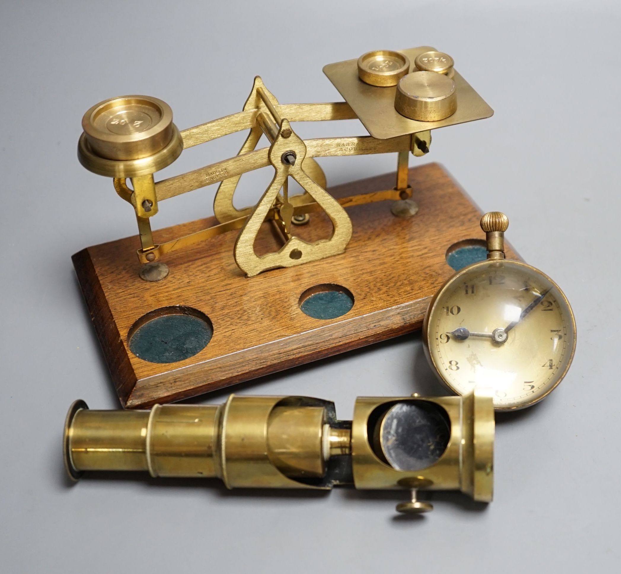 A student's brass monocular microscope, a pair of letter scales and a desk watch, Letter scales 17cms wide.